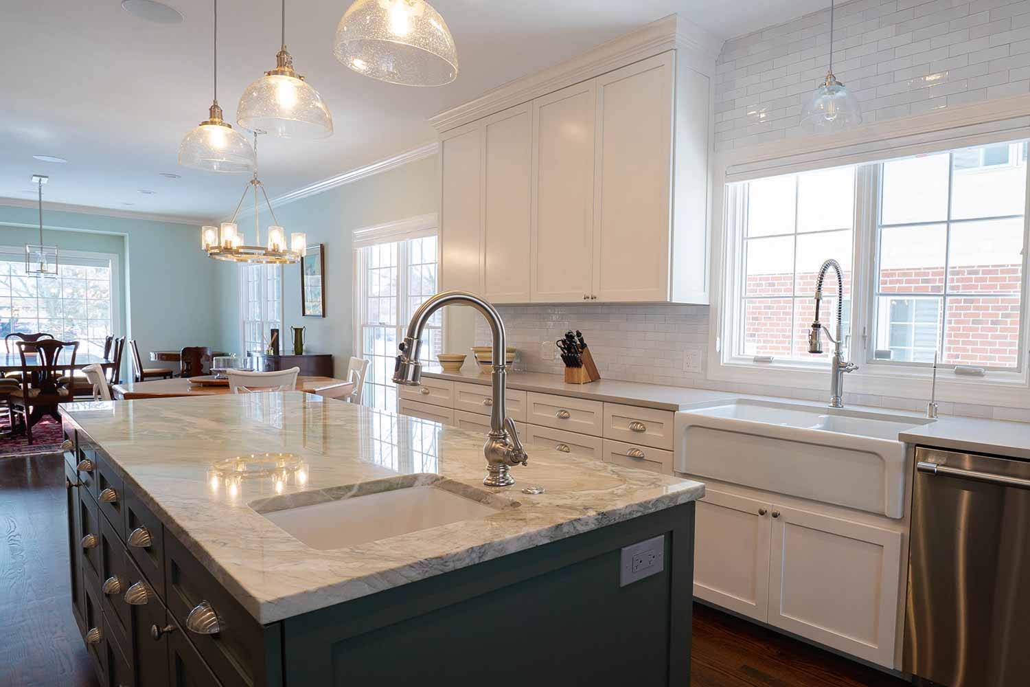Marble countertops and white cabinets and island interior remodel.